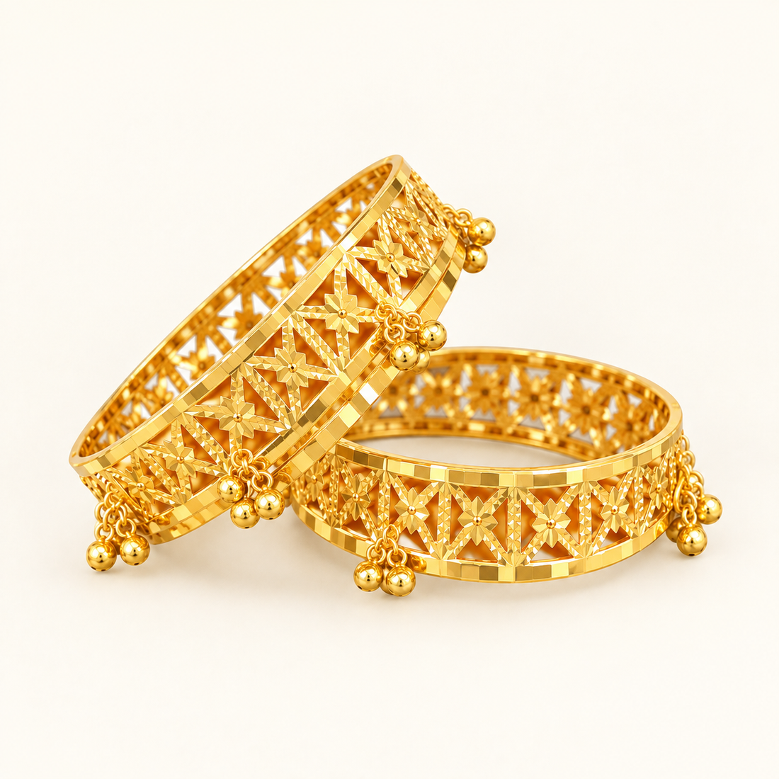 Pair of 22K gold bell bangles with intricate openwork, front product view
